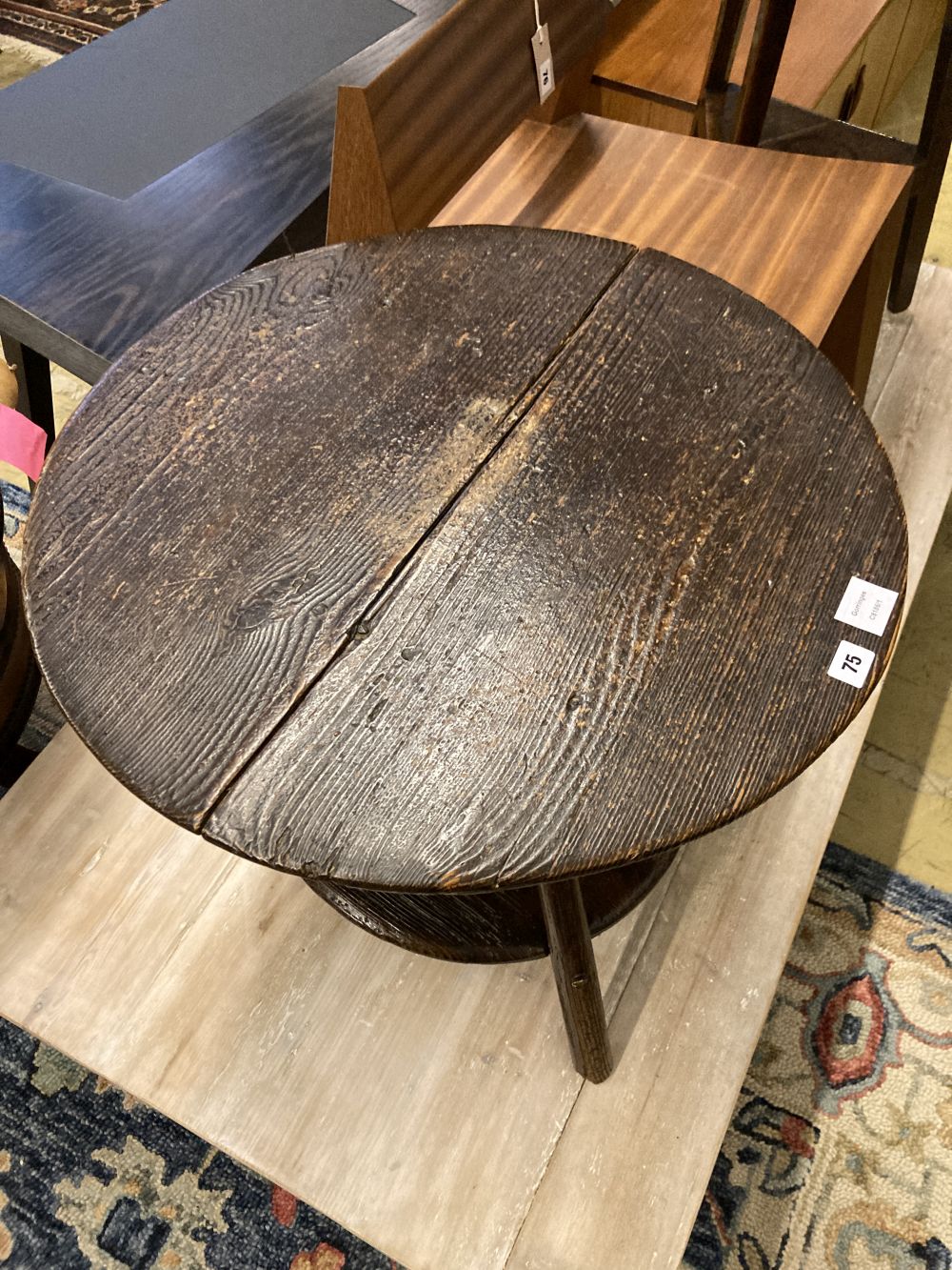 An 18th century pine cricket table, with undertier, 63cm diameter, height 56cm